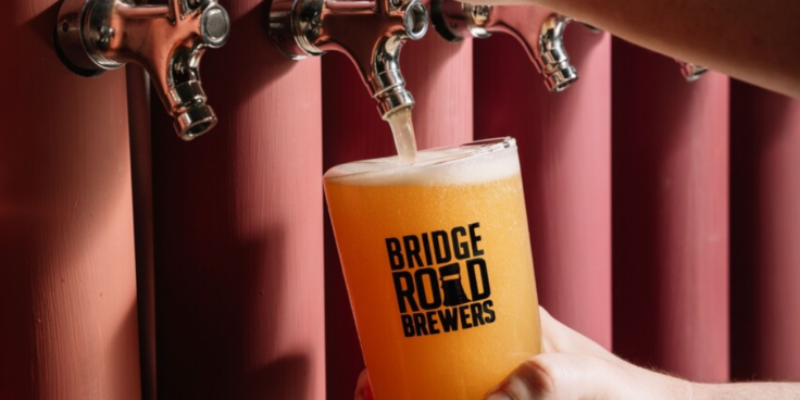 Person filling Bridge Road Brewers glass with beer